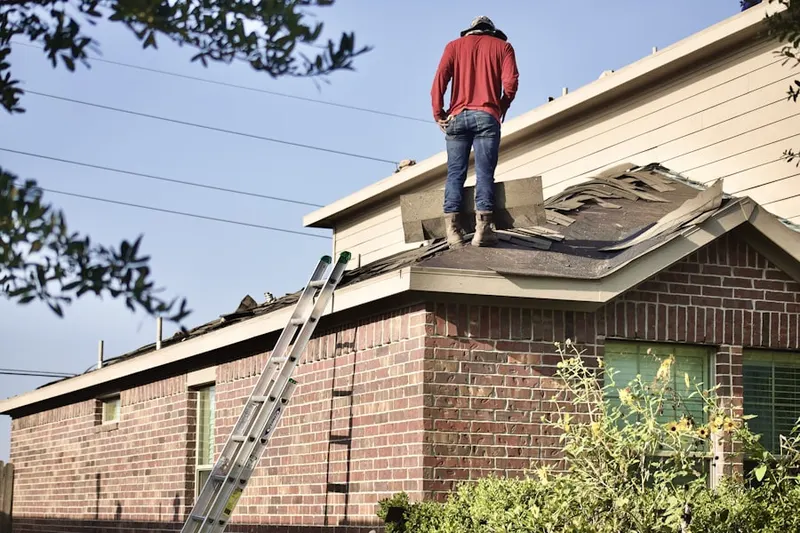 Professional roofer working on a residential roof in Charbonneau